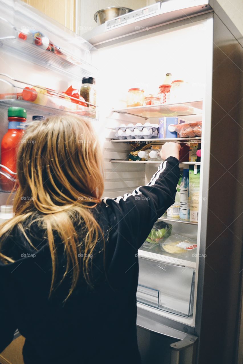 Girl using refrigerator