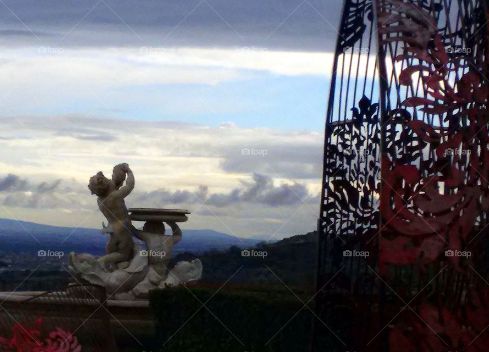 Scenic clouds view from the panoramic terrace with fountain and putti statues