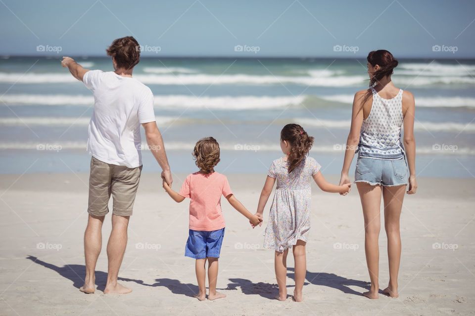 Shadow of family having a good time at the beach