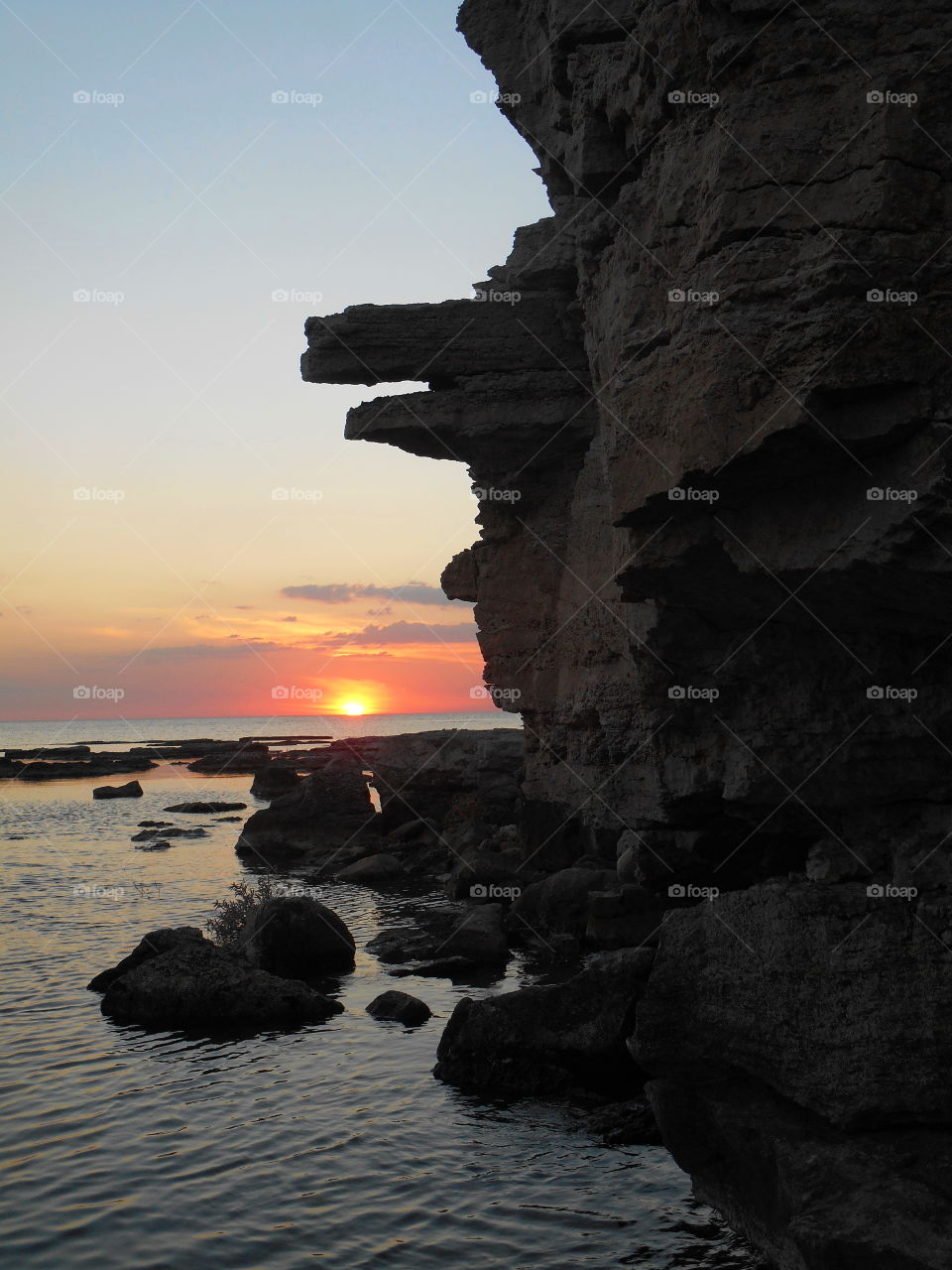 stone rock face sunset on a sea nature abstract, adventure travel