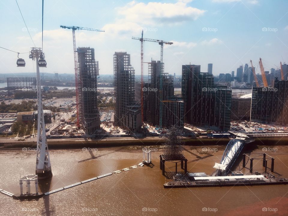 View south from an Emirates Air Line cable car across the River Thames, over Greenwich Peninsula 