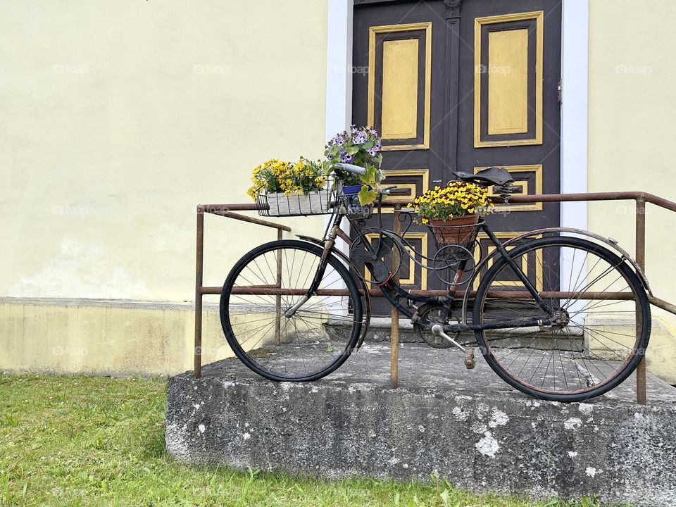 Black bicycle with flowers outdoor 