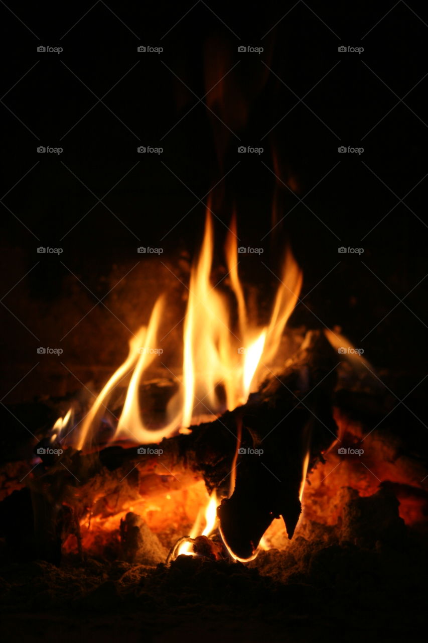 wood burning in the dark in chimney