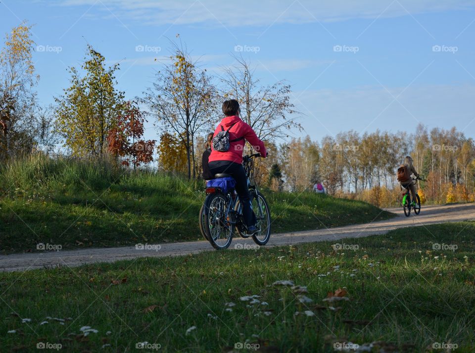 people riding on a bikes autumn beautiful landscape