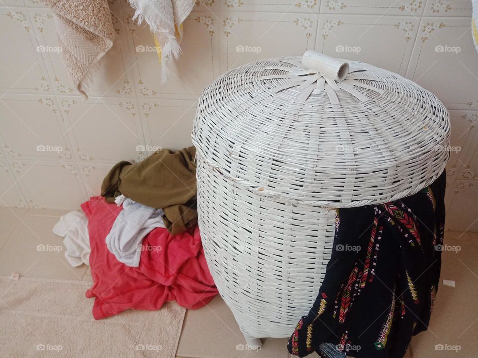 round laundry basket with laundry to do