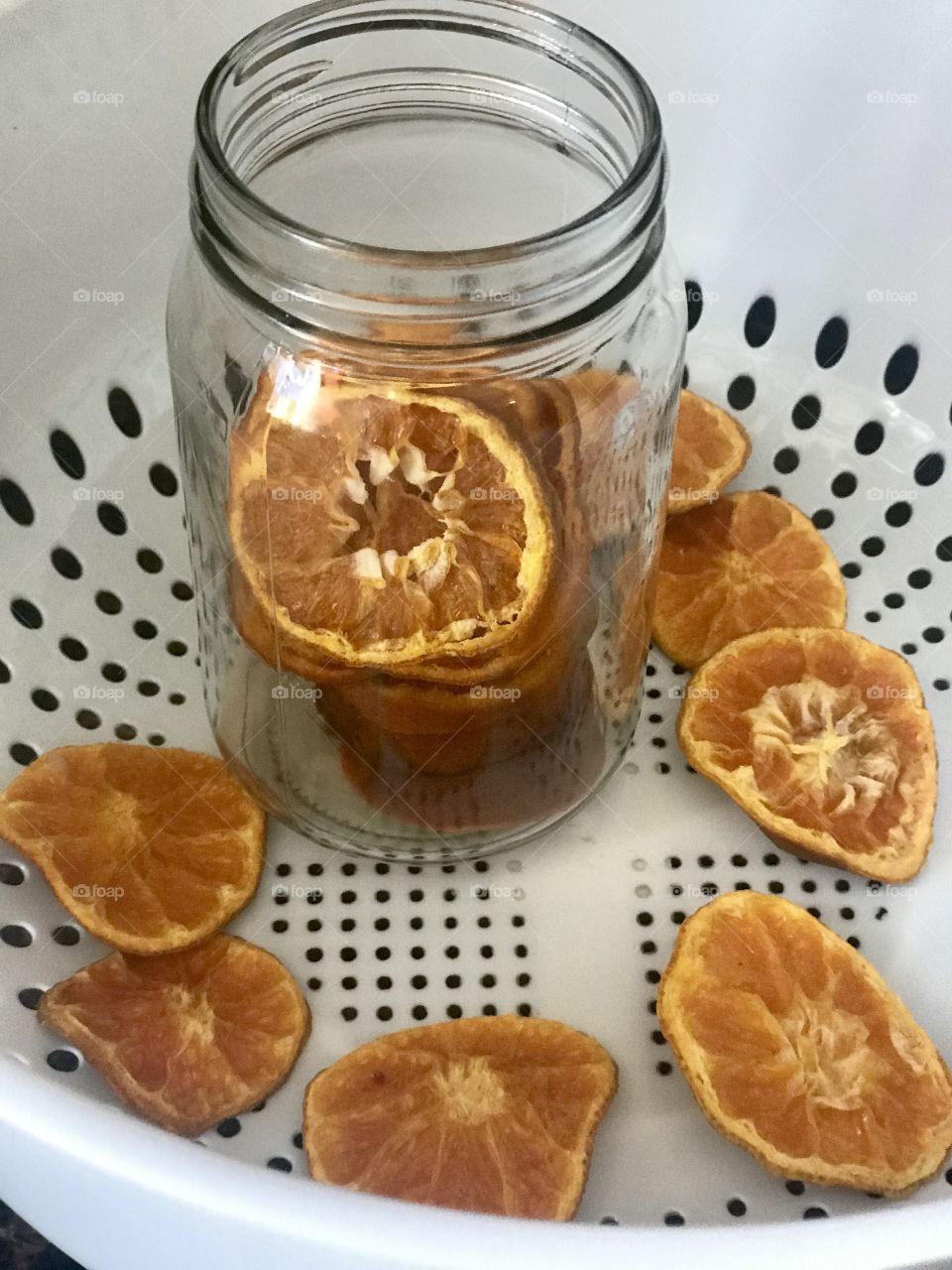Dried, dehydrated fruit orange slices in a glass mason jar 