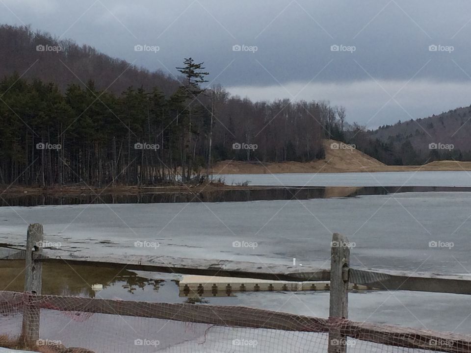 View across frozen lake in Snowshoe, West Virginia