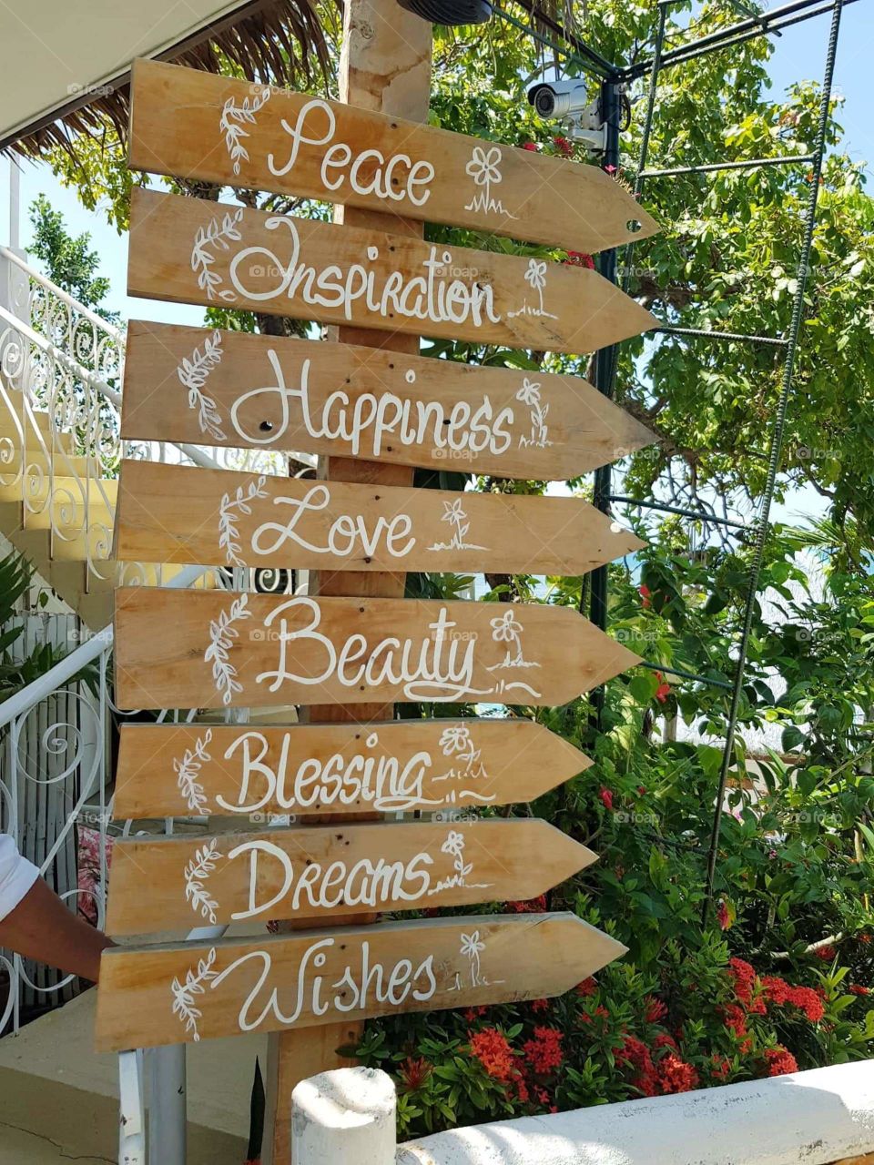 Wooden signage located outside of a beach wedding venue.
