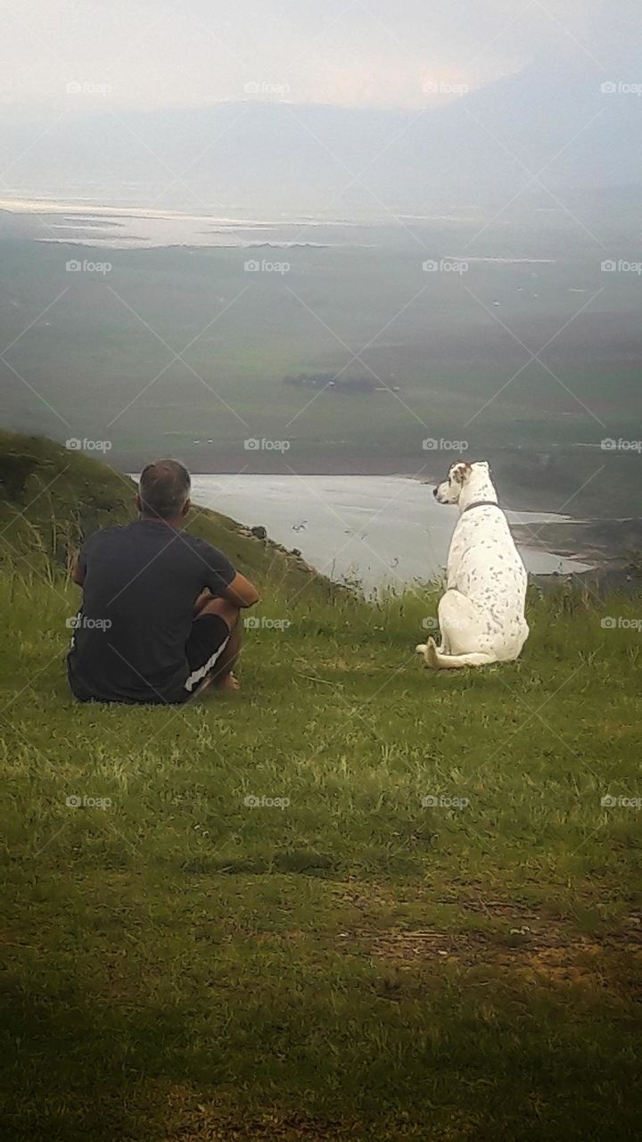 just a man and his dog enjoying nature.