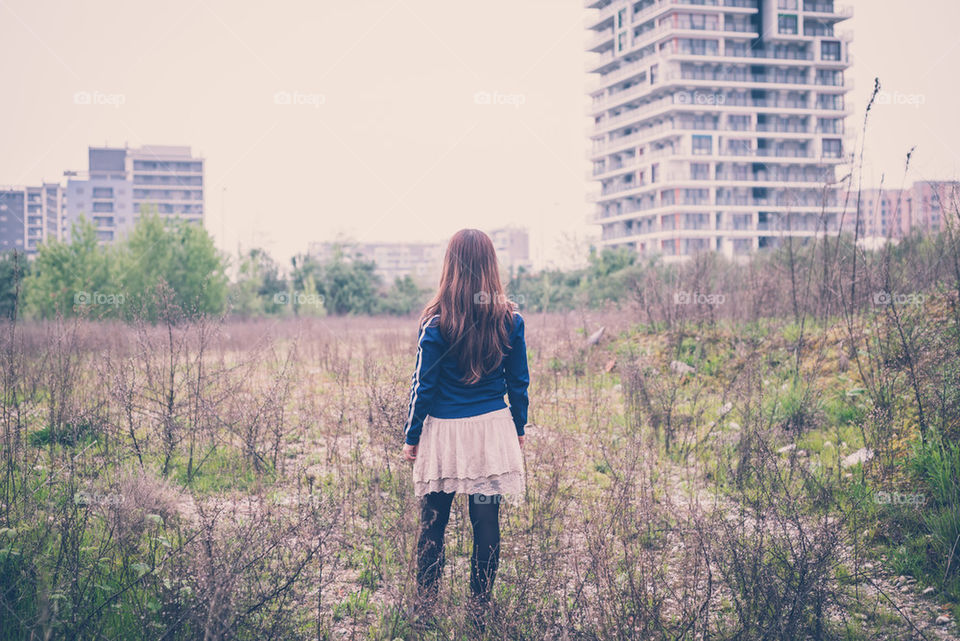 woman back looking desolate landscape