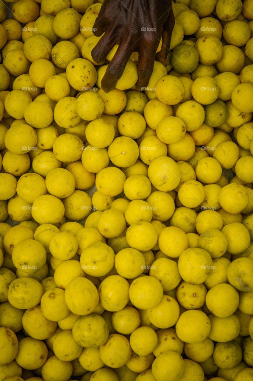 Old lady was selling these lemons on a footpath. i grabbed my camera and took a shot of this when she was picking up some lemons
