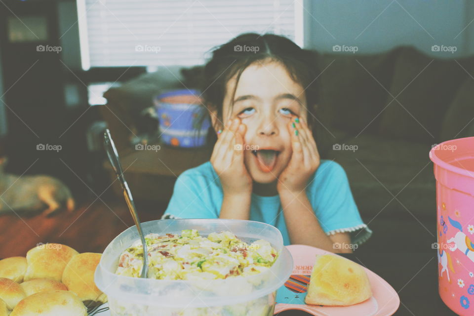 little girl making silly face