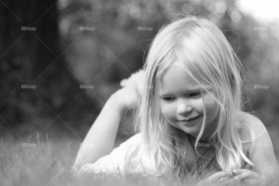 Little girl playing in the grass