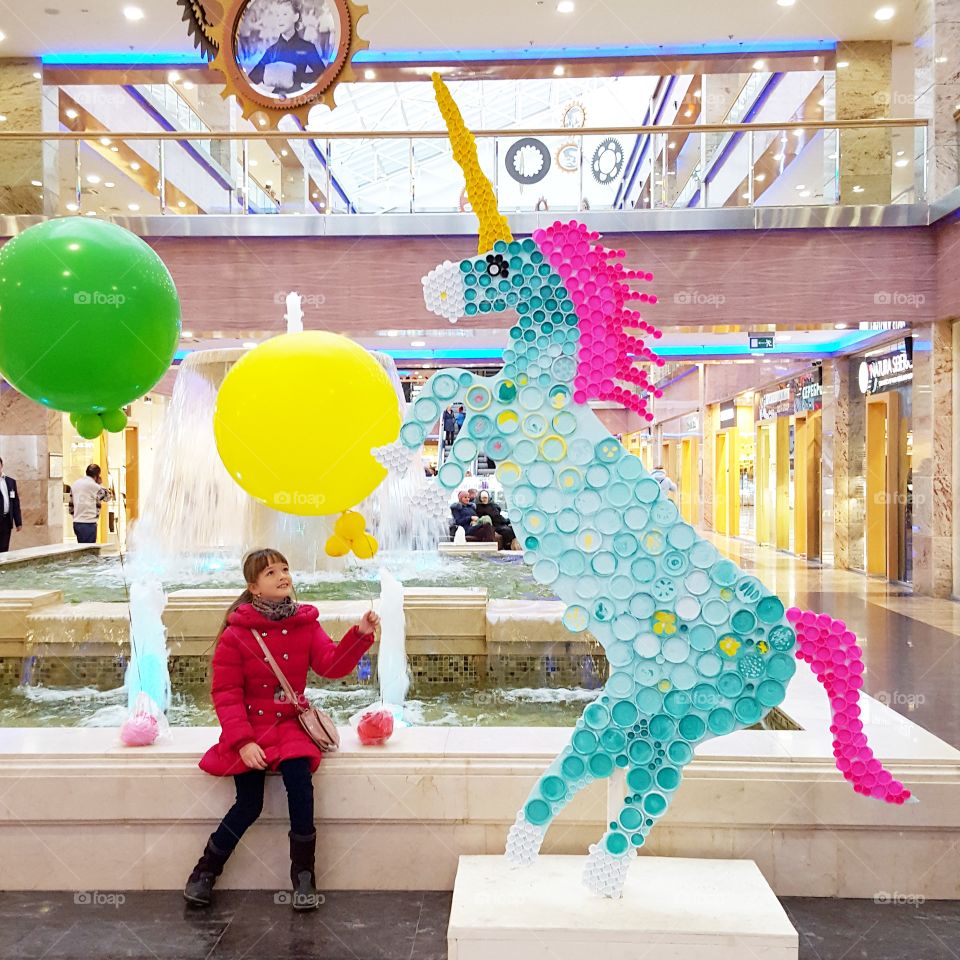 Colorful horse near the fountain in mall