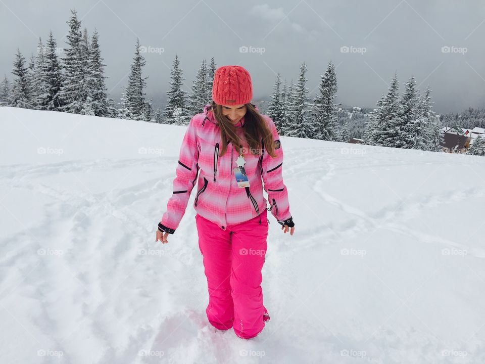 Woman in pink ski costume enjoying snow