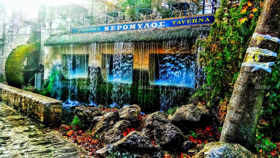 Traditional tavern "Neromylos" with running watrs coming from the roof and a watermill.Piges Kryas,Livadeia
