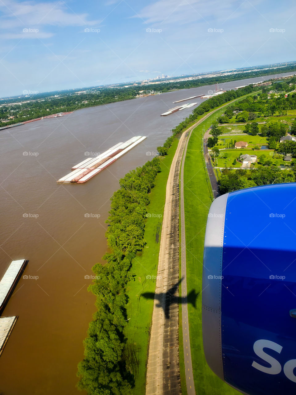 The jet aircraft is reflected as a shadow as I fly over the Sacramento delta in California