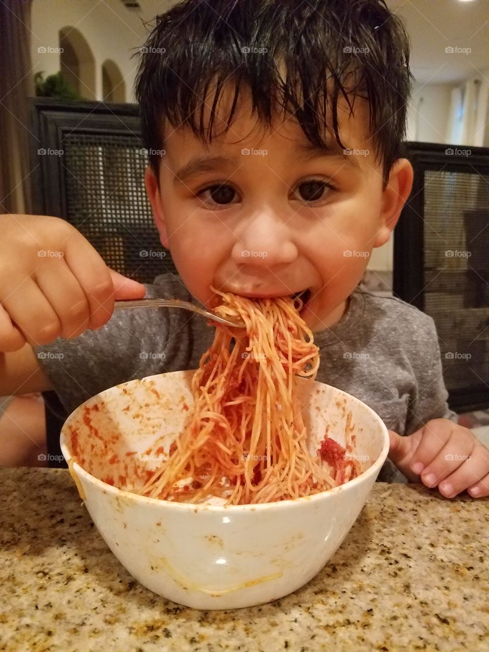 Portrait of boy eating noodles
