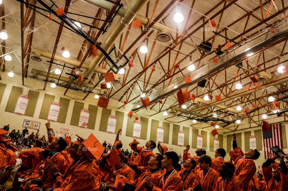 Students throwing their graduation hat during ceremony