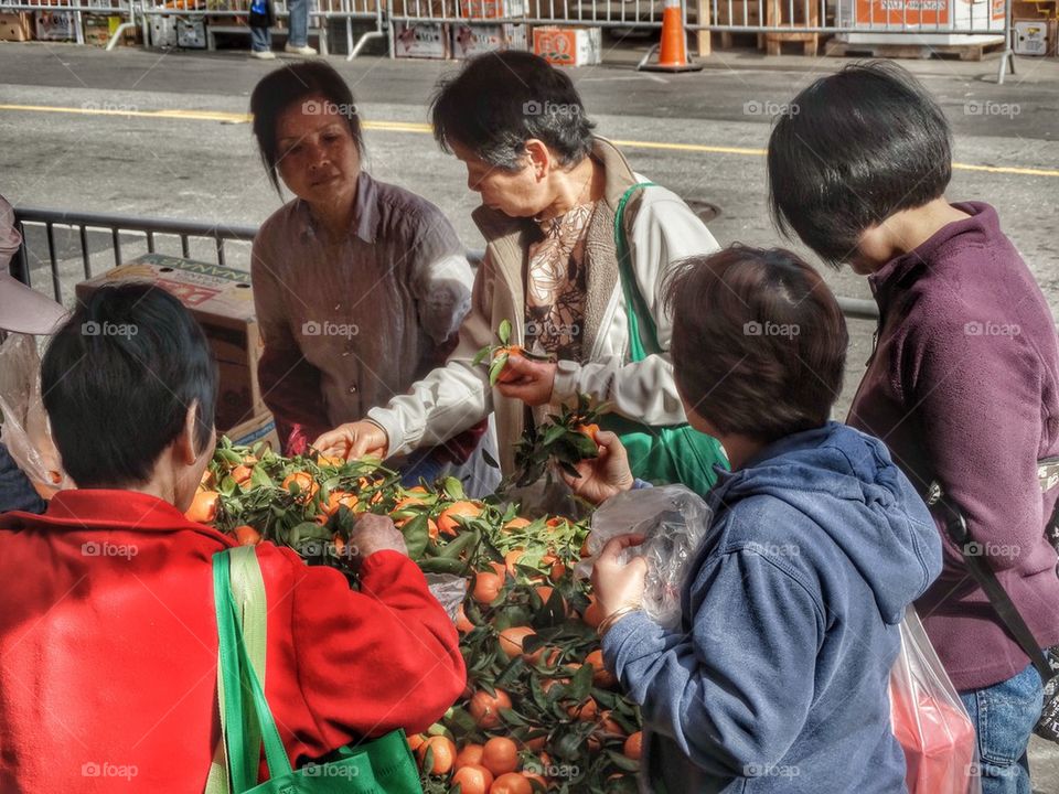 Buying Fruit In A Chinese Street Market. Shopping In A Chinese Street Market
