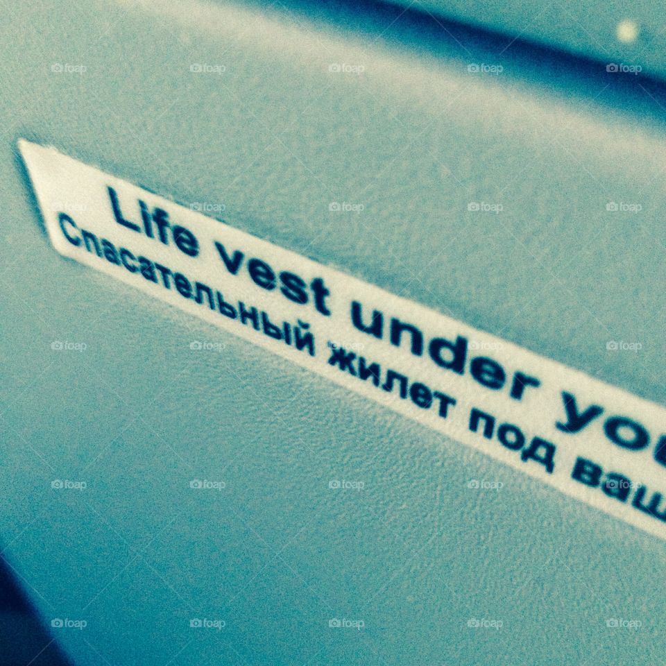 In airplane. Life vest under your seat