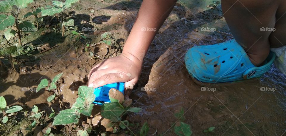 children playing muddy ground