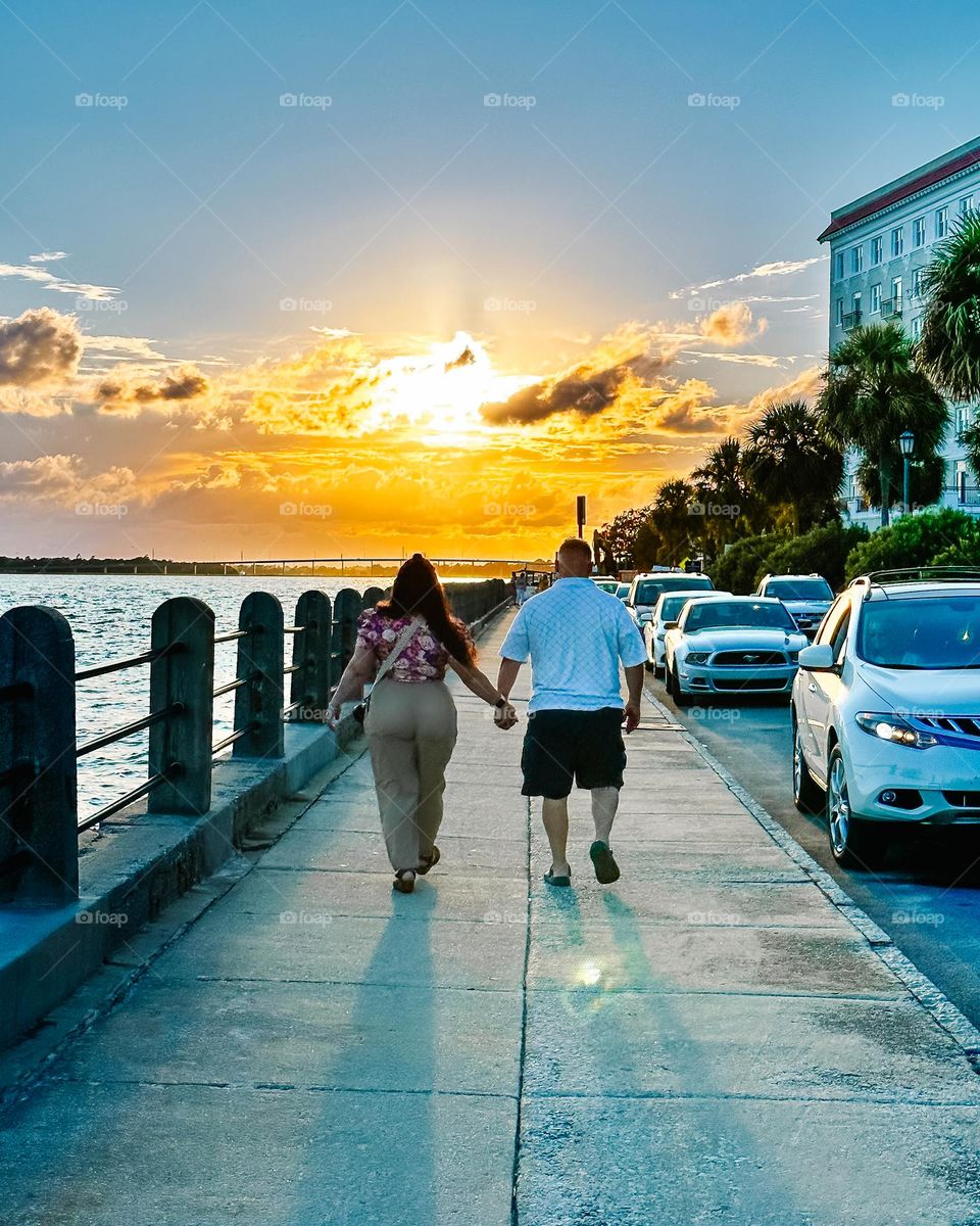 Couple holding hands as they celebrate their anniversary!