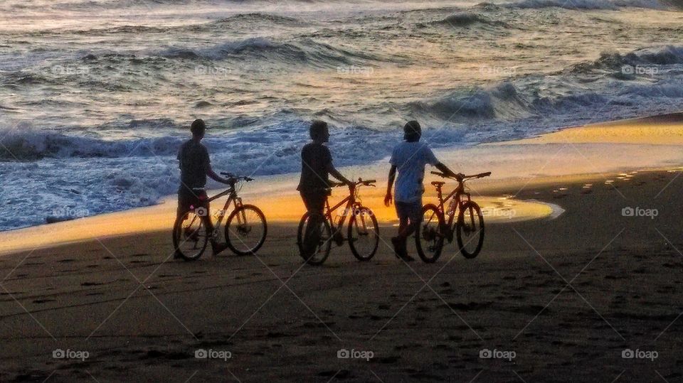 Three pals in Bali having a stroll on the beach and what better time to pick!?