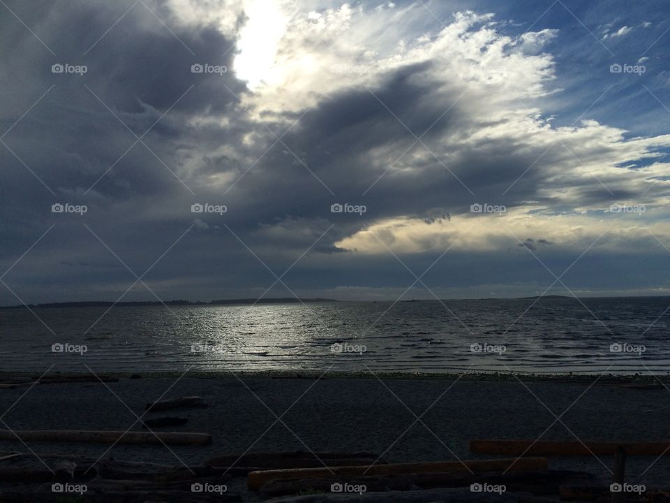 Scenic view of sea against storm cloud