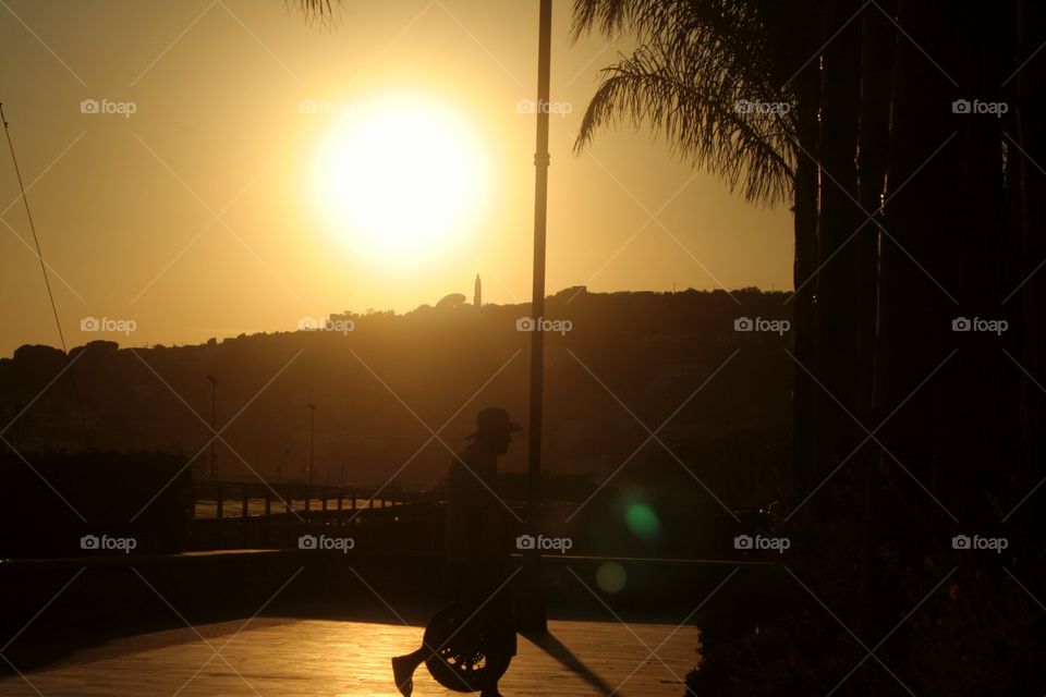 Walking worker at sunset