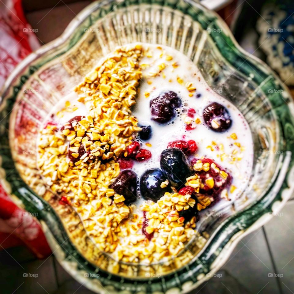 Making a smoothie in a blender with berries & coconut milk