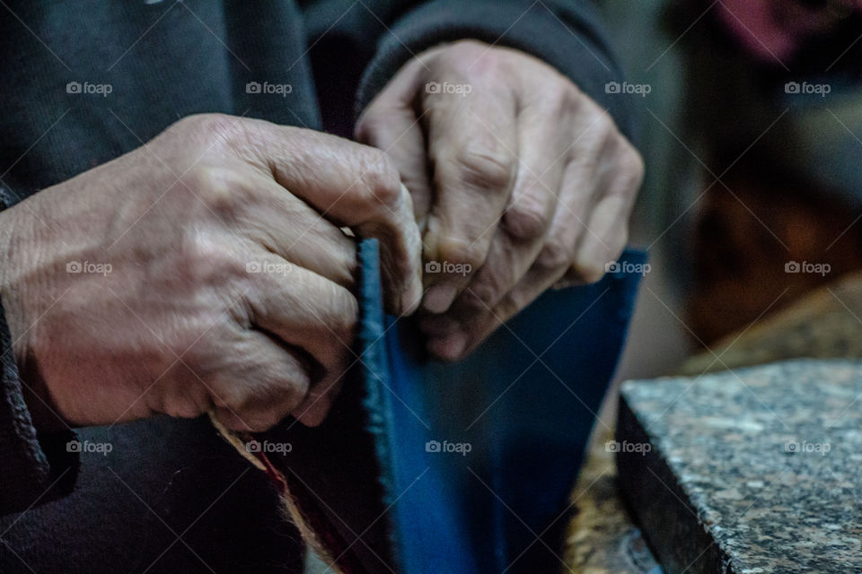 Man creating handmade purses