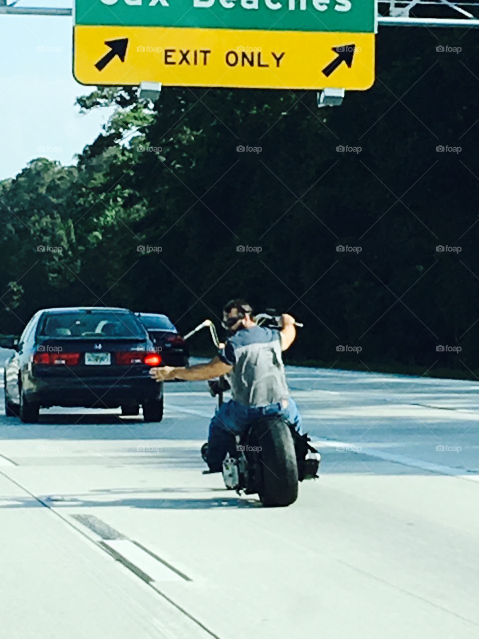 Custom Harley, no helmet, left signal, traffic!