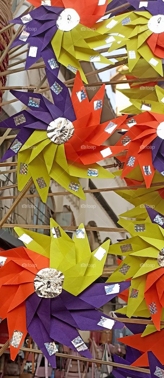 art piece made for especially kids made up of colored paper, wooden stick and glue beautiful complementary colors in one piece