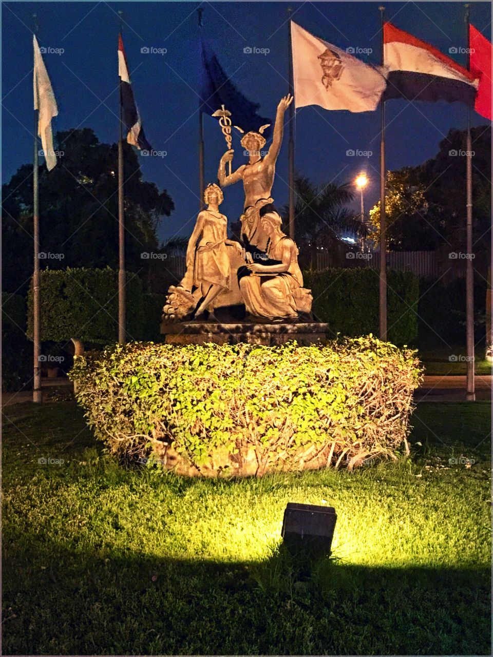 Cairo Opera House, Zamalik, Egypt. Shows the beauty of sculpture at night with special lighting technique, in the background flags of different countries and nations to show unity ❤️