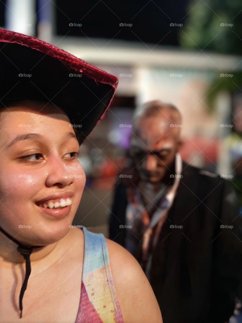 Girl with affable and bright eyes smiling in the night.