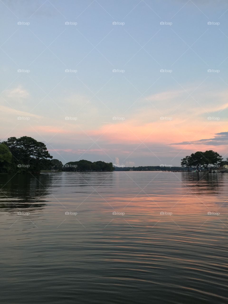 This soft Southern sunset is reflected in the ripple-filled lake water, reminding us of how each choice made ripples further than we can see....