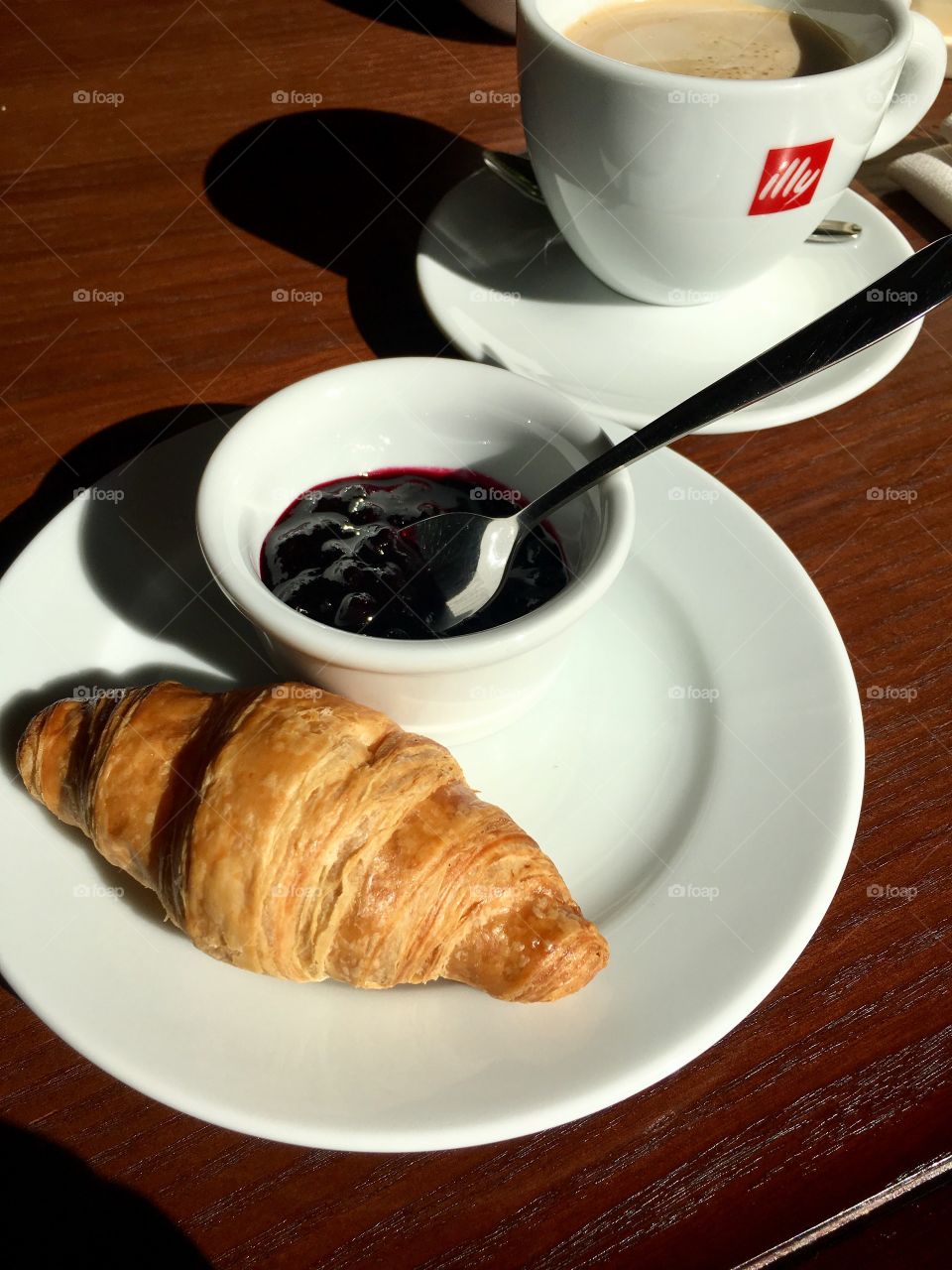 Croissant with jam and coffee
