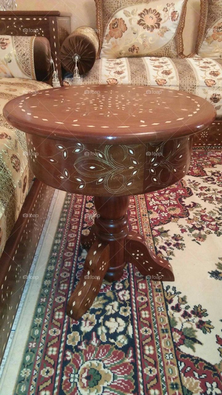 Small brown table made of wood.