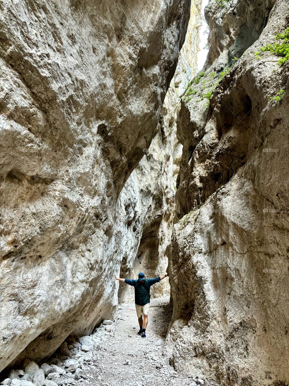 A man touches both sides of a narrow gorge in the Gole di San Martino in Fara San Martino, Abruzzo, Italy.