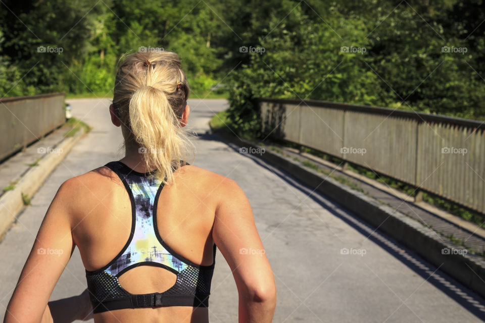 Rear view of a fitness woman jogging