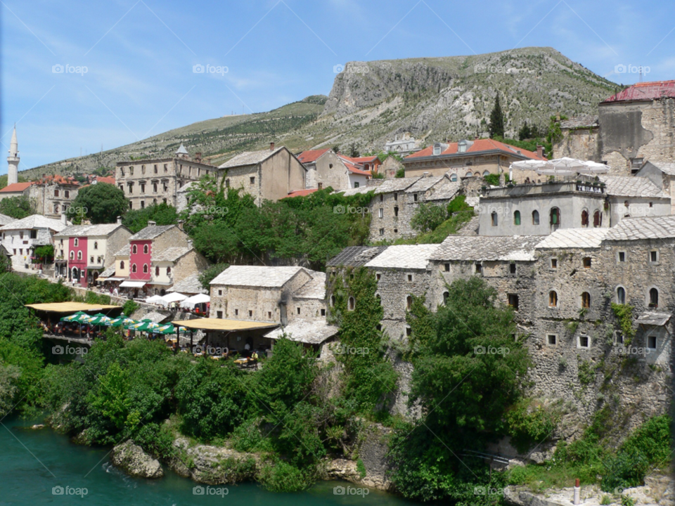 mountain blue sky old buildings mostar by auscro