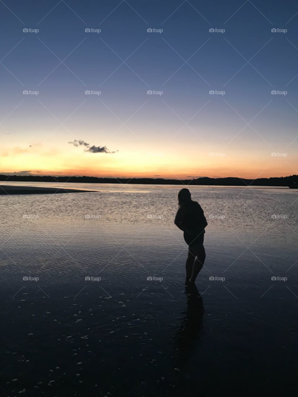 Woman on the beach at sunset