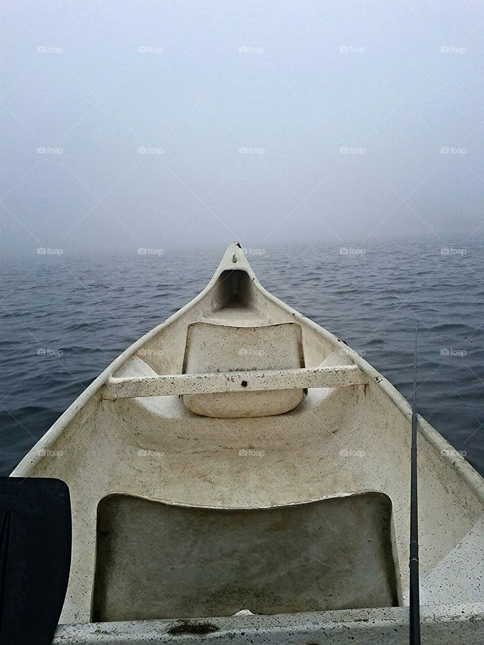 Boat at sea and view of fog