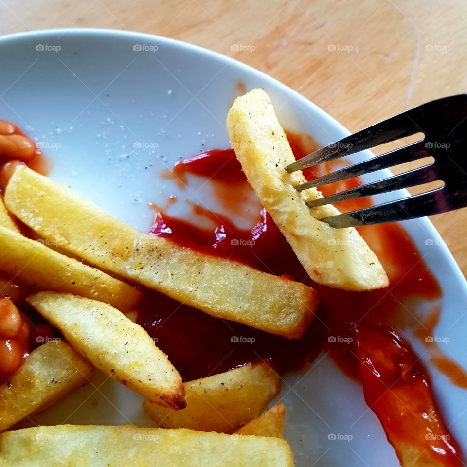Chunky fries fork ketchup baked beans messy