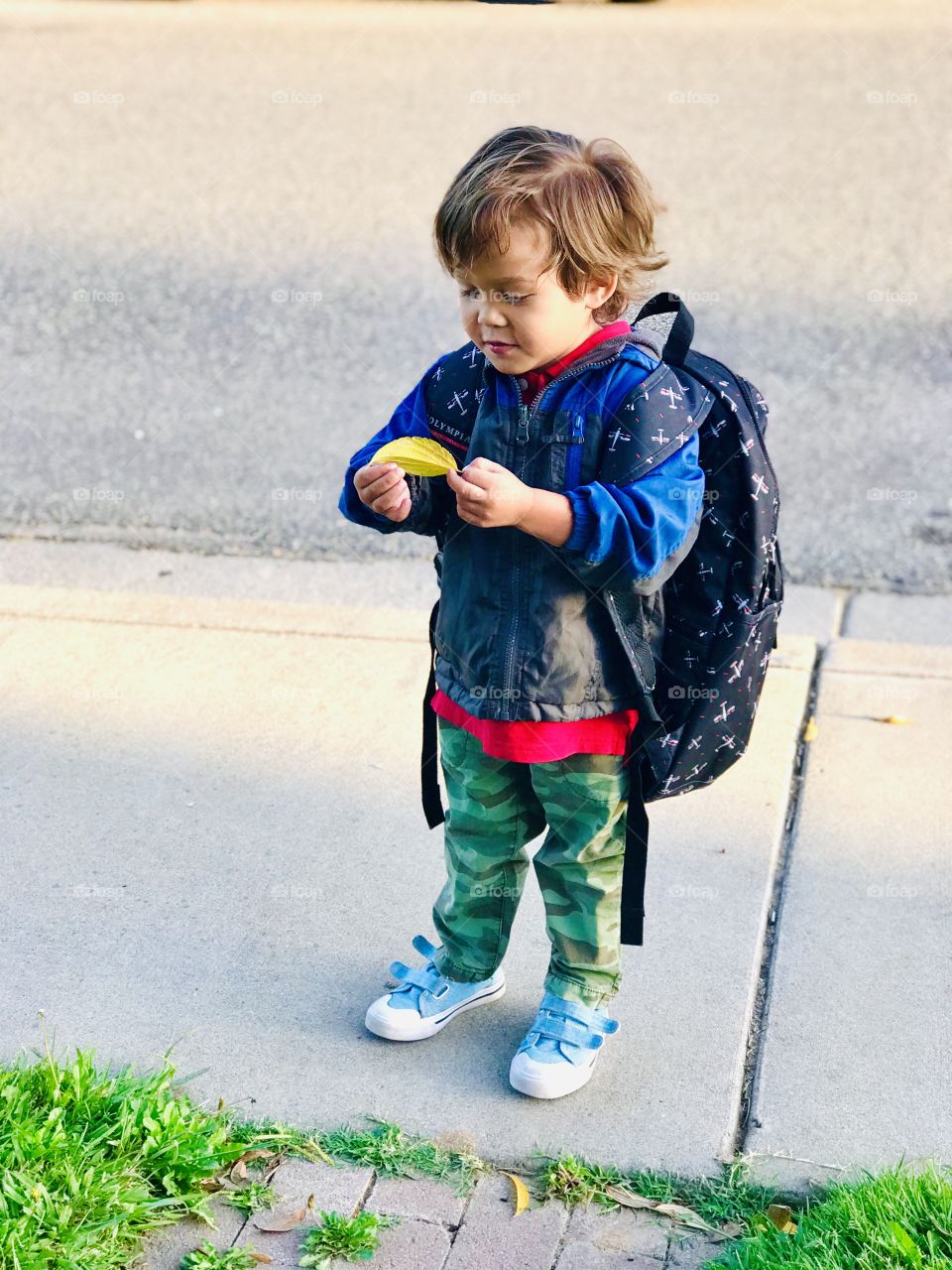 My Buddy is holding the first left of the Autumn season and he was happy to see the yellow color. 
