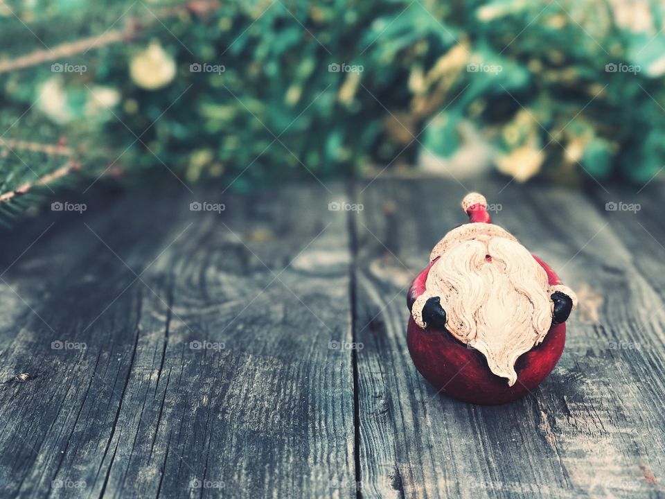 Christmas Santa Claus on a gray wooden surface, vintage toning