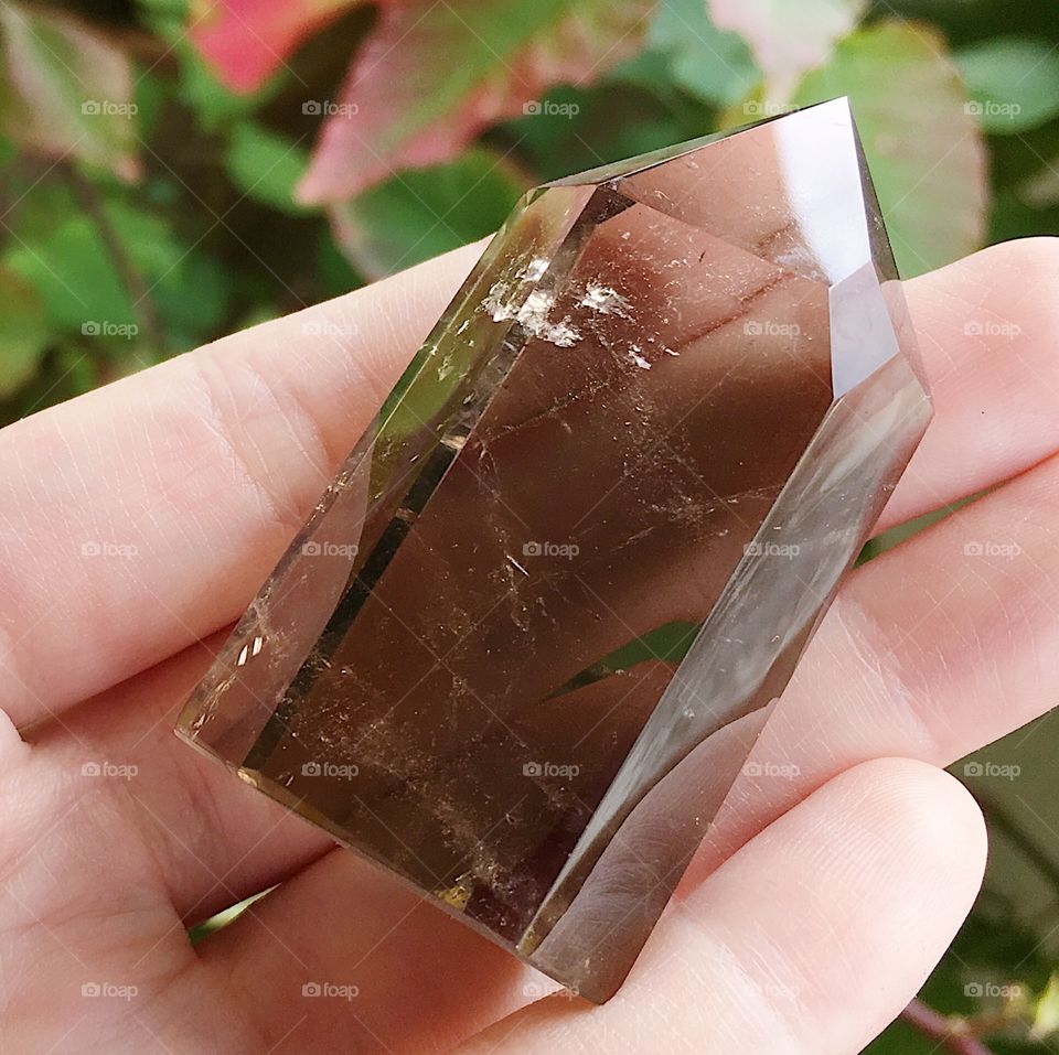 A polished smoky quartz crystal point.