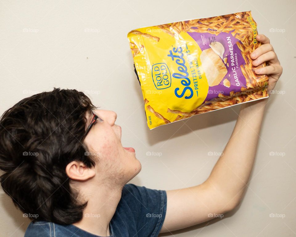 Stuffing his face with pretzels