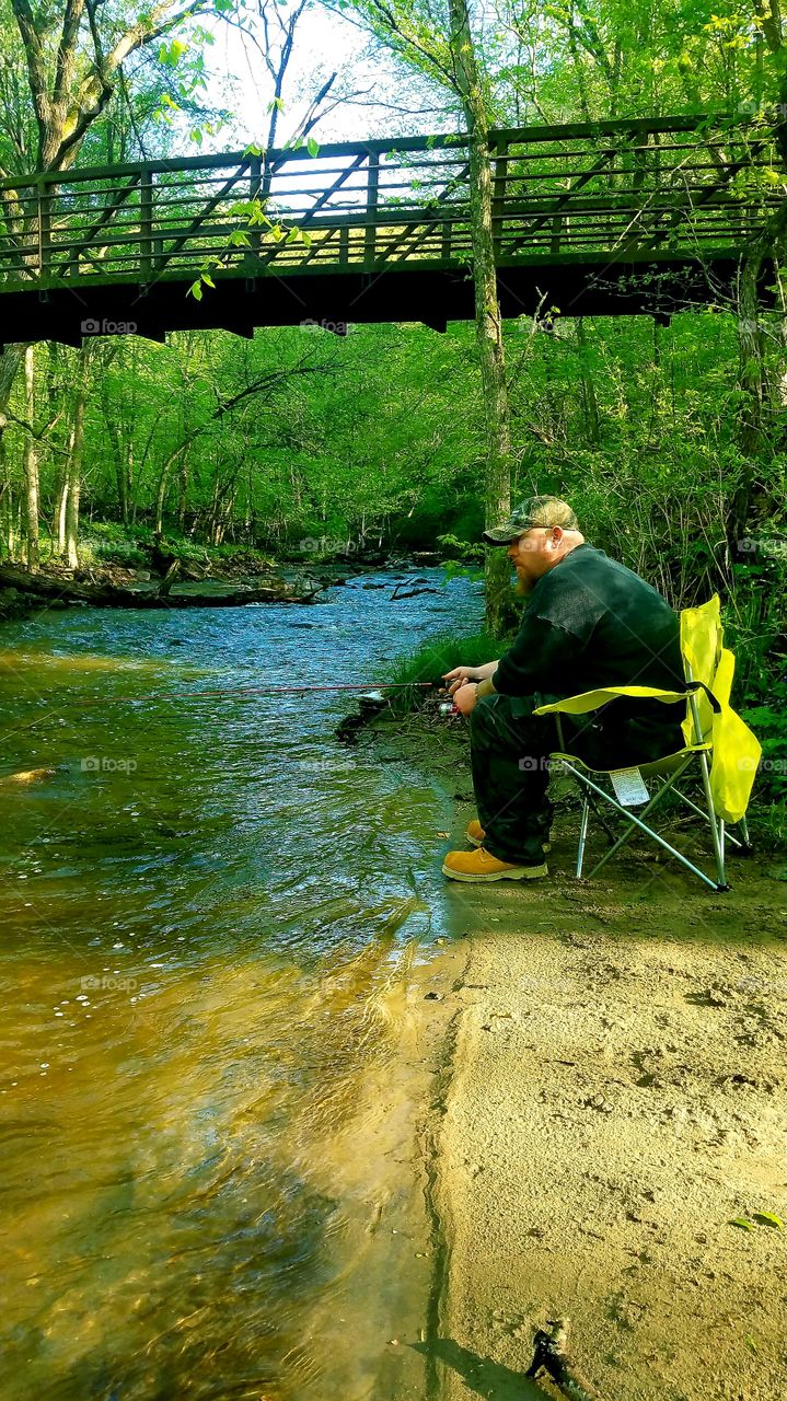 man fishing Minnesota river